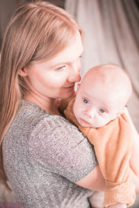 a man in a suit kissing a baby