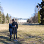 a man and woman hugging in a field