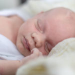 a baby sleeping on a blanket Newborn Shooting